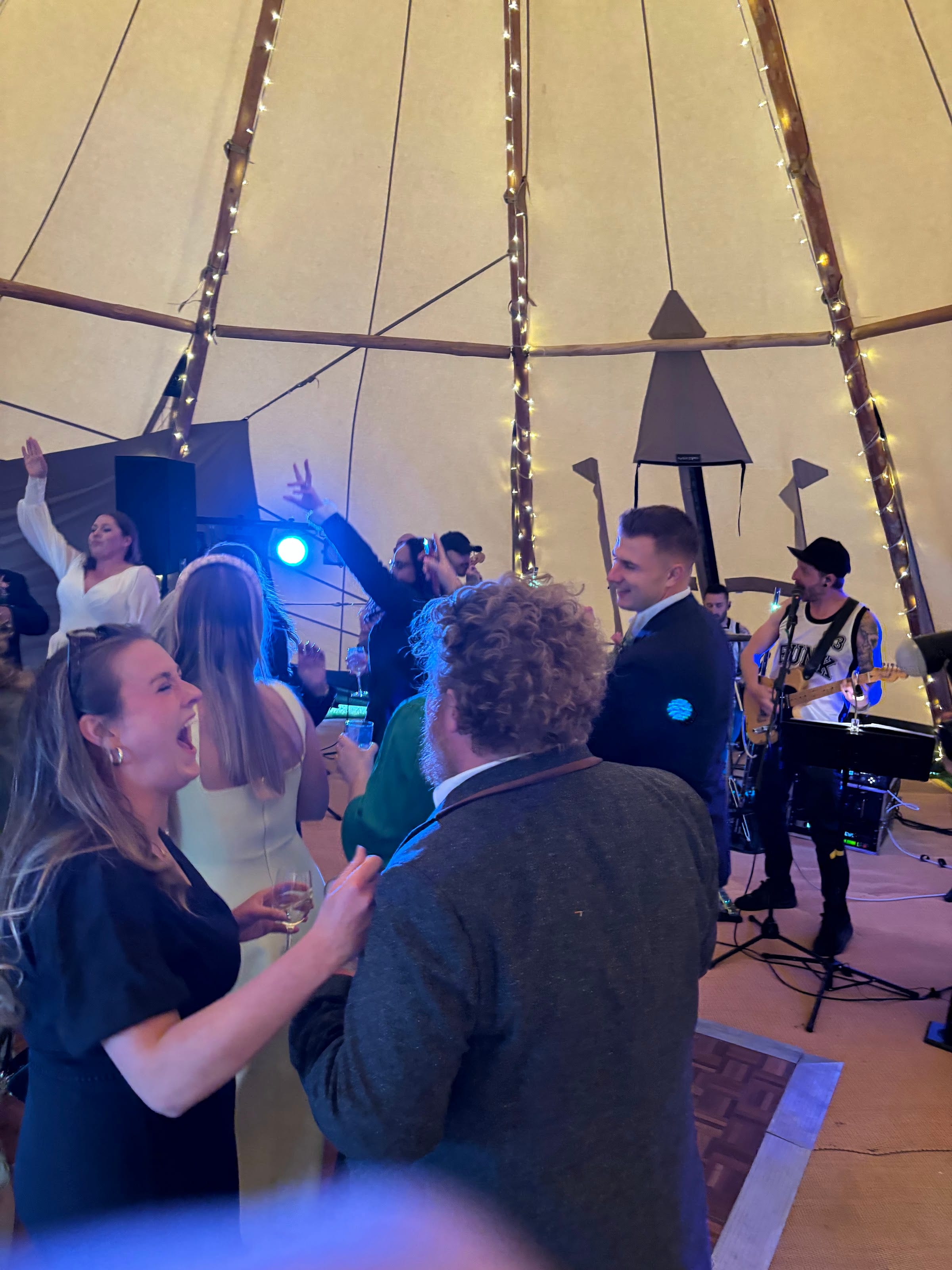 A guest laughing mid-song as the band plays behind her